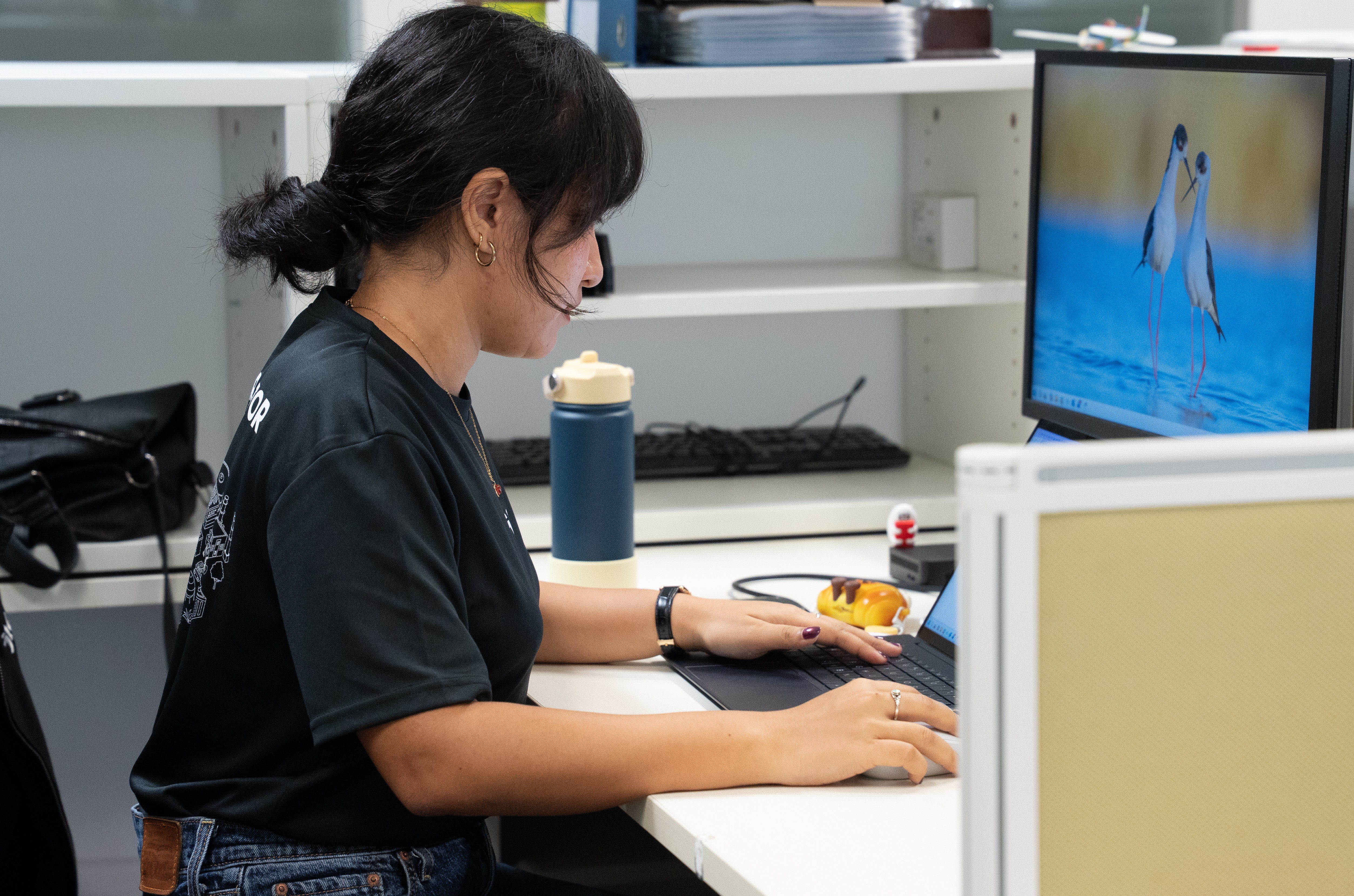 Employee facing her monitor