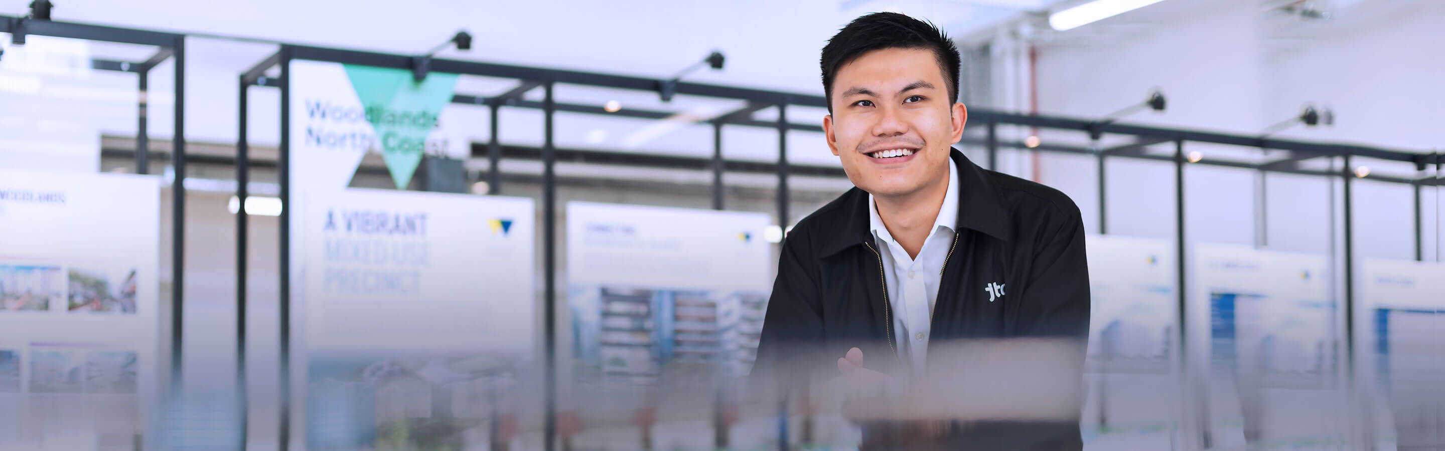 A man poses with a building model