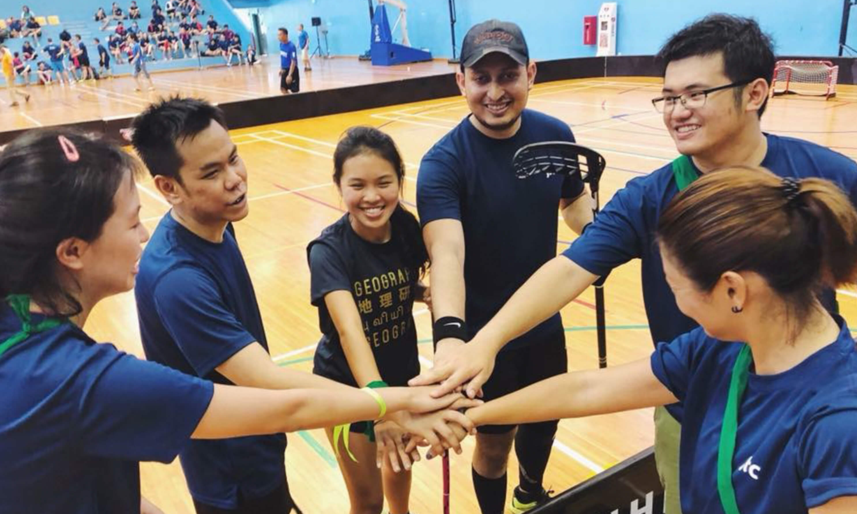 A team of hockey players with their hands in