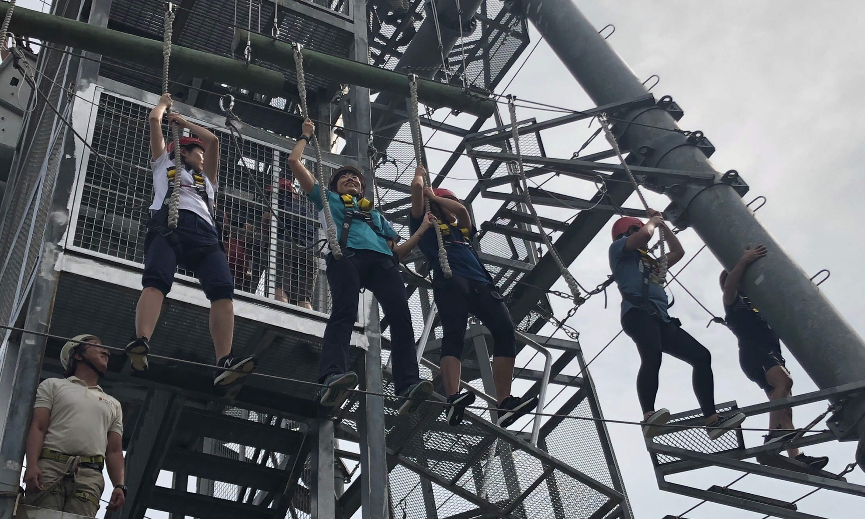 A group of people doing a high element obstacle course