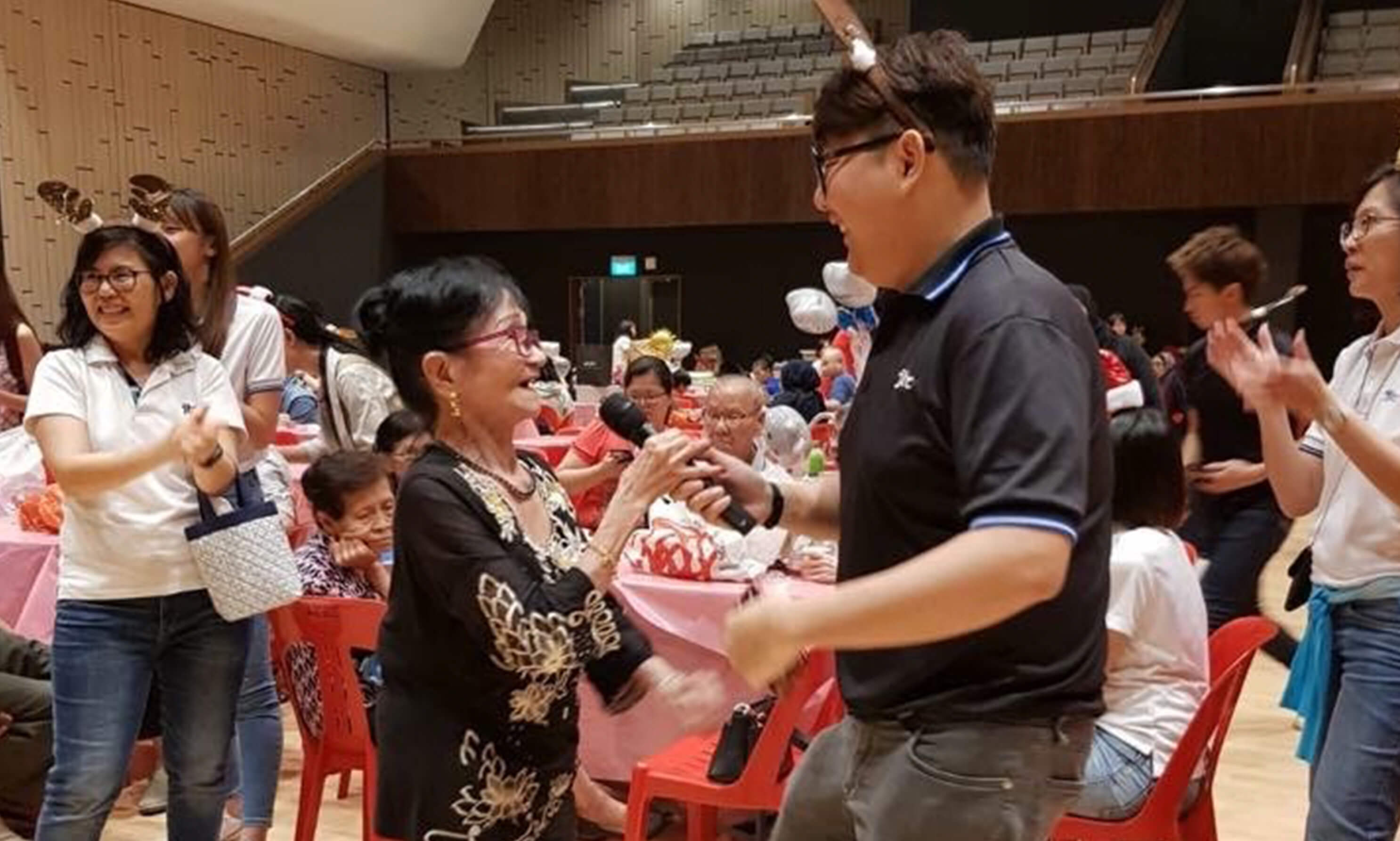 People engaging with the elderly at an event