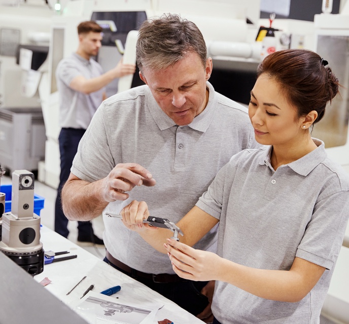 Workers measuring components in a lab