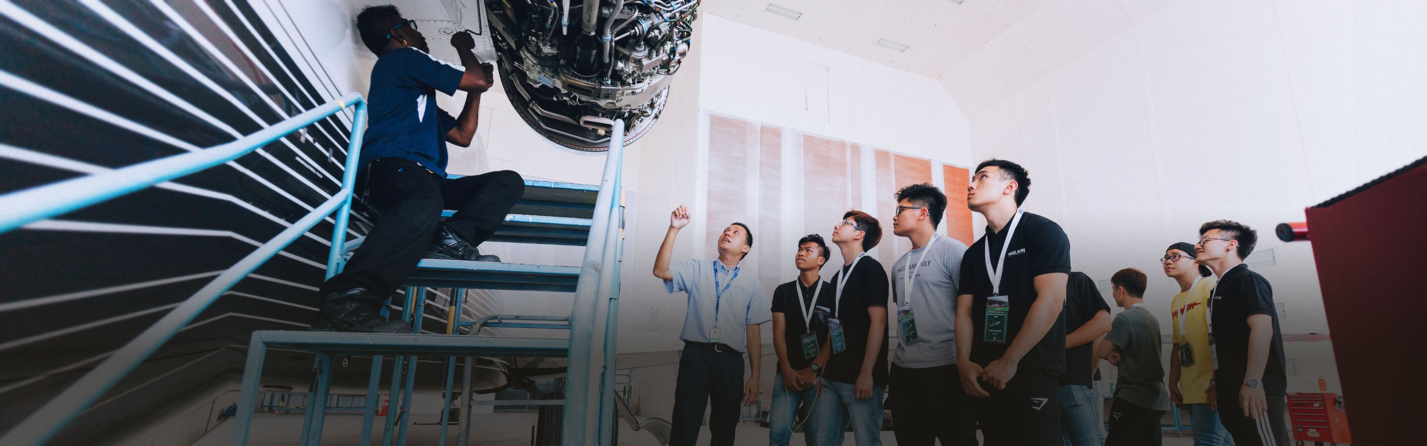 A man leading a group of guests on a tour of an advanced manufacturing facility