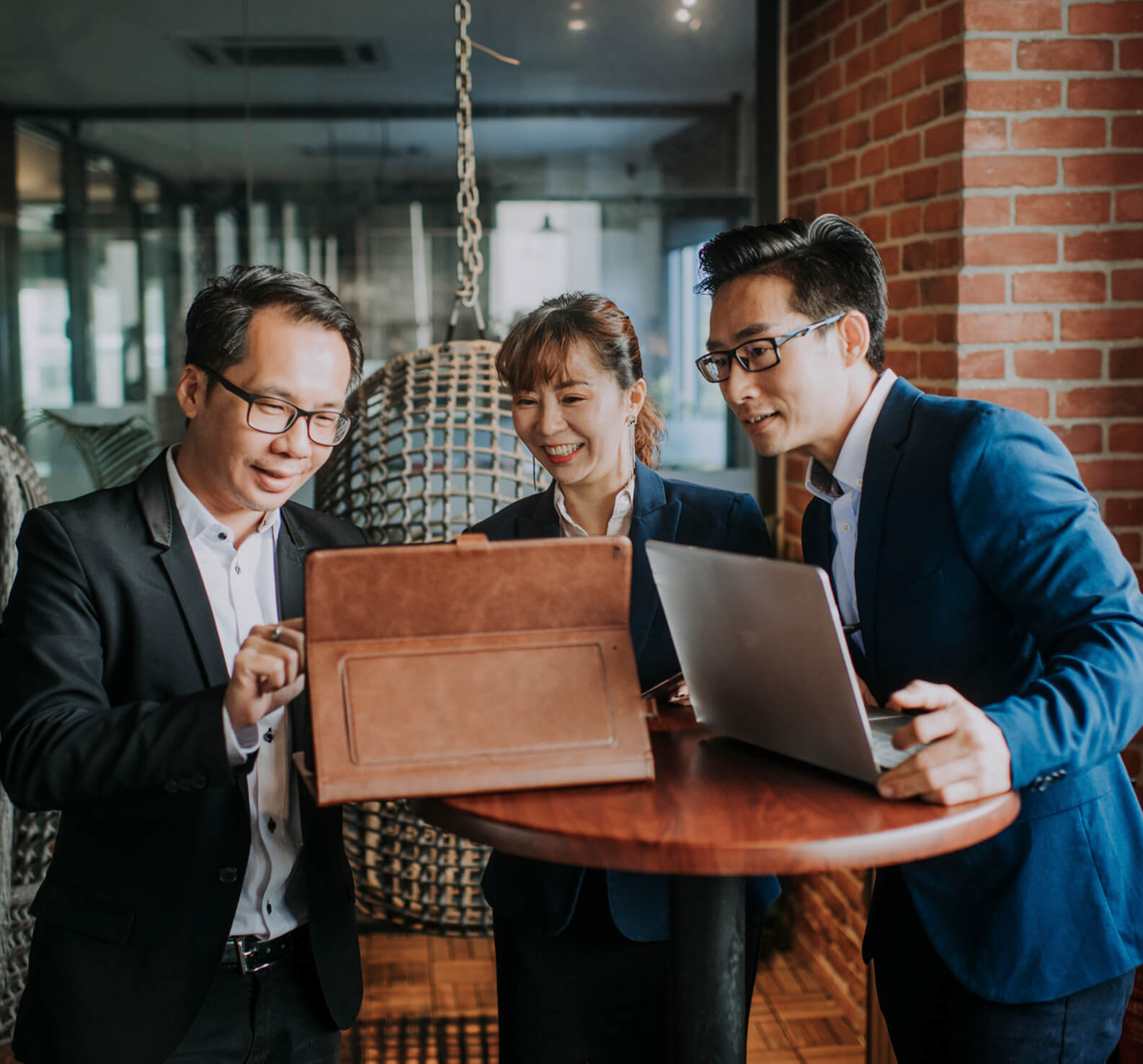 Three professionals in suits having a meeting