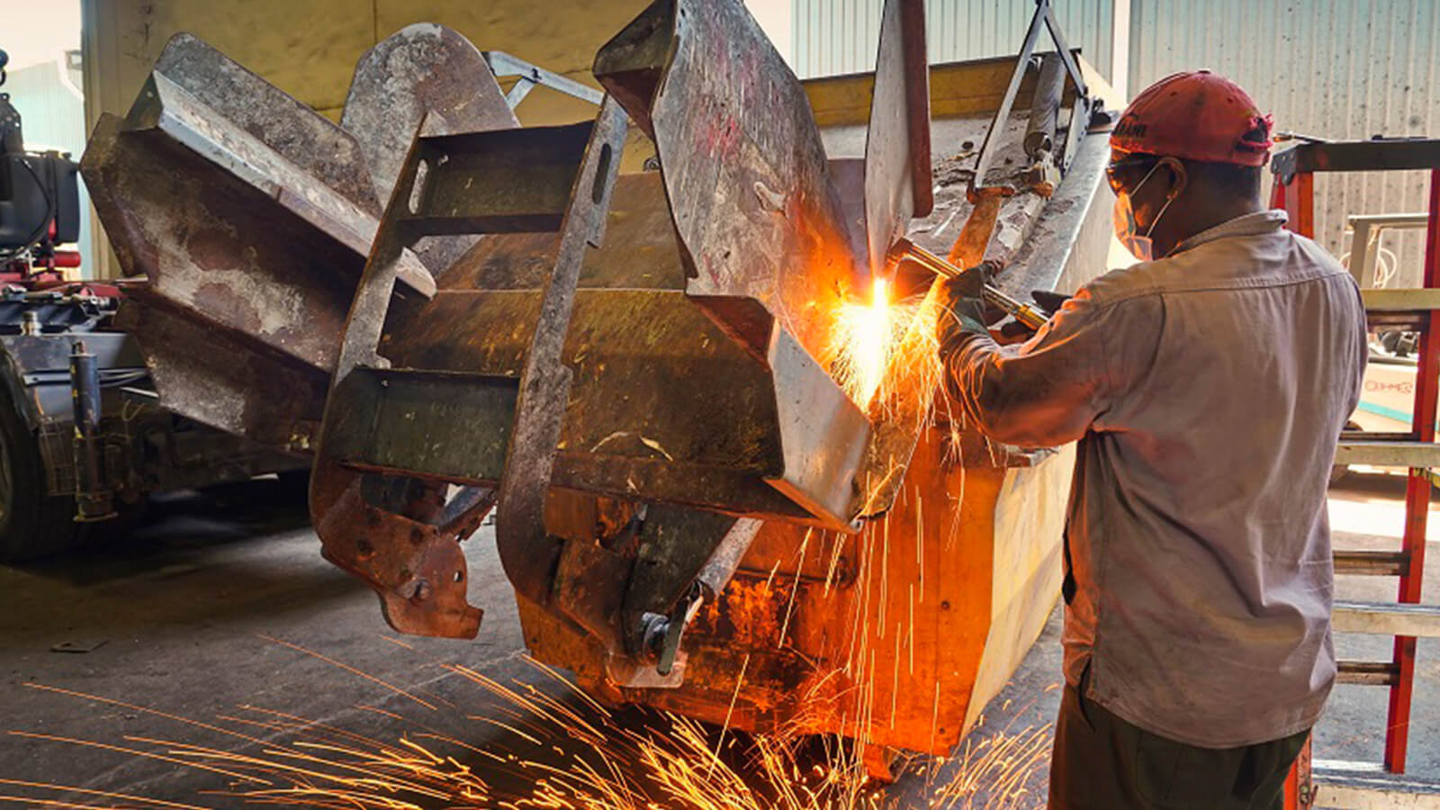 A Beng Hock employee repairing a waste compactor