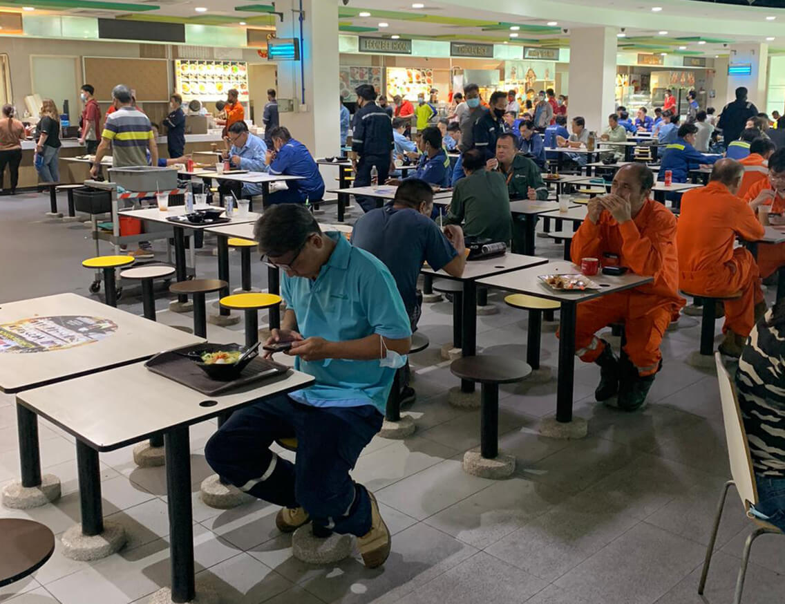 People eating in a crowded food court