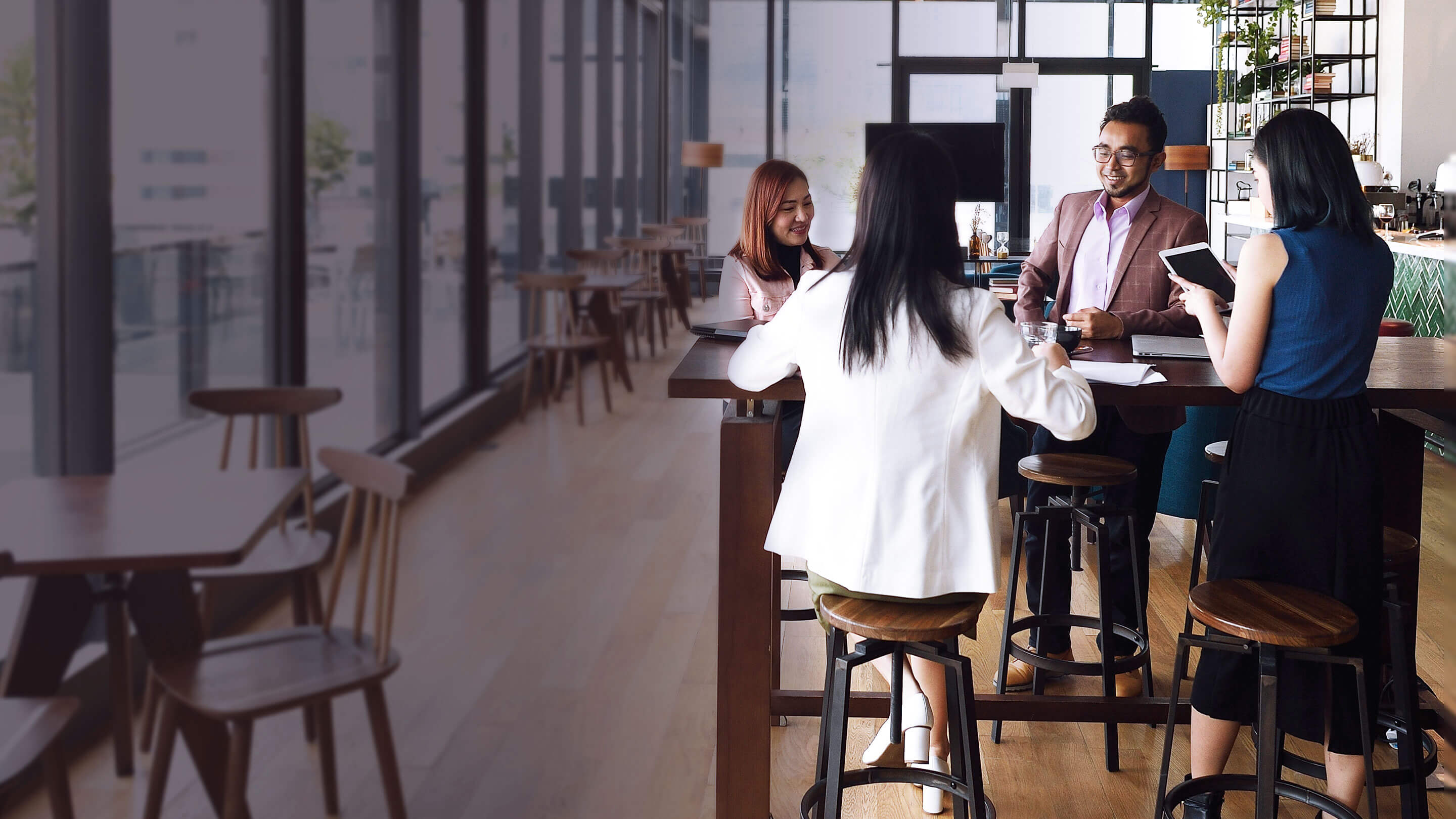 Employees having an informal meeting in a cafe setting