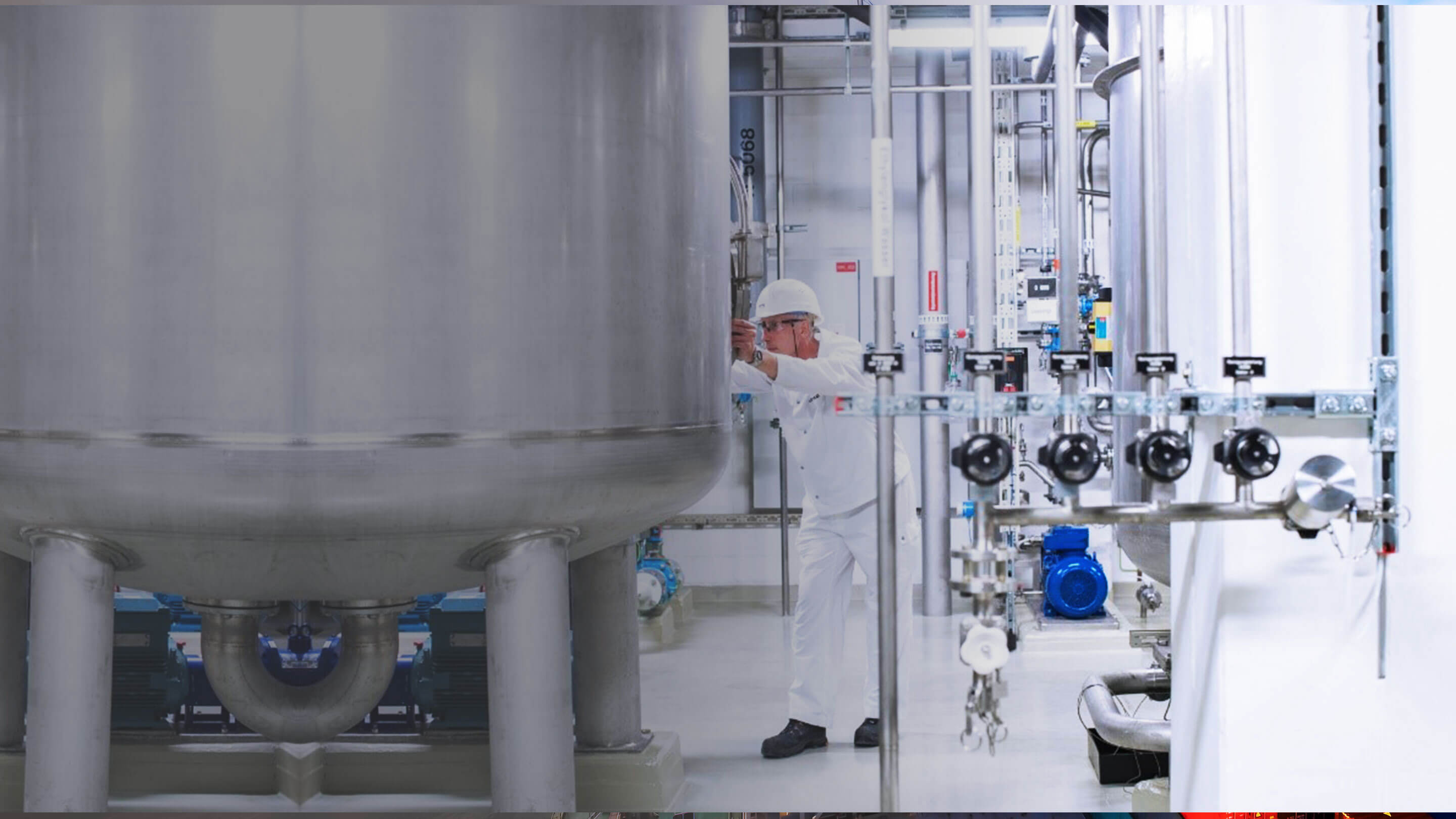 An employee in a helmet conducts checks in a facility