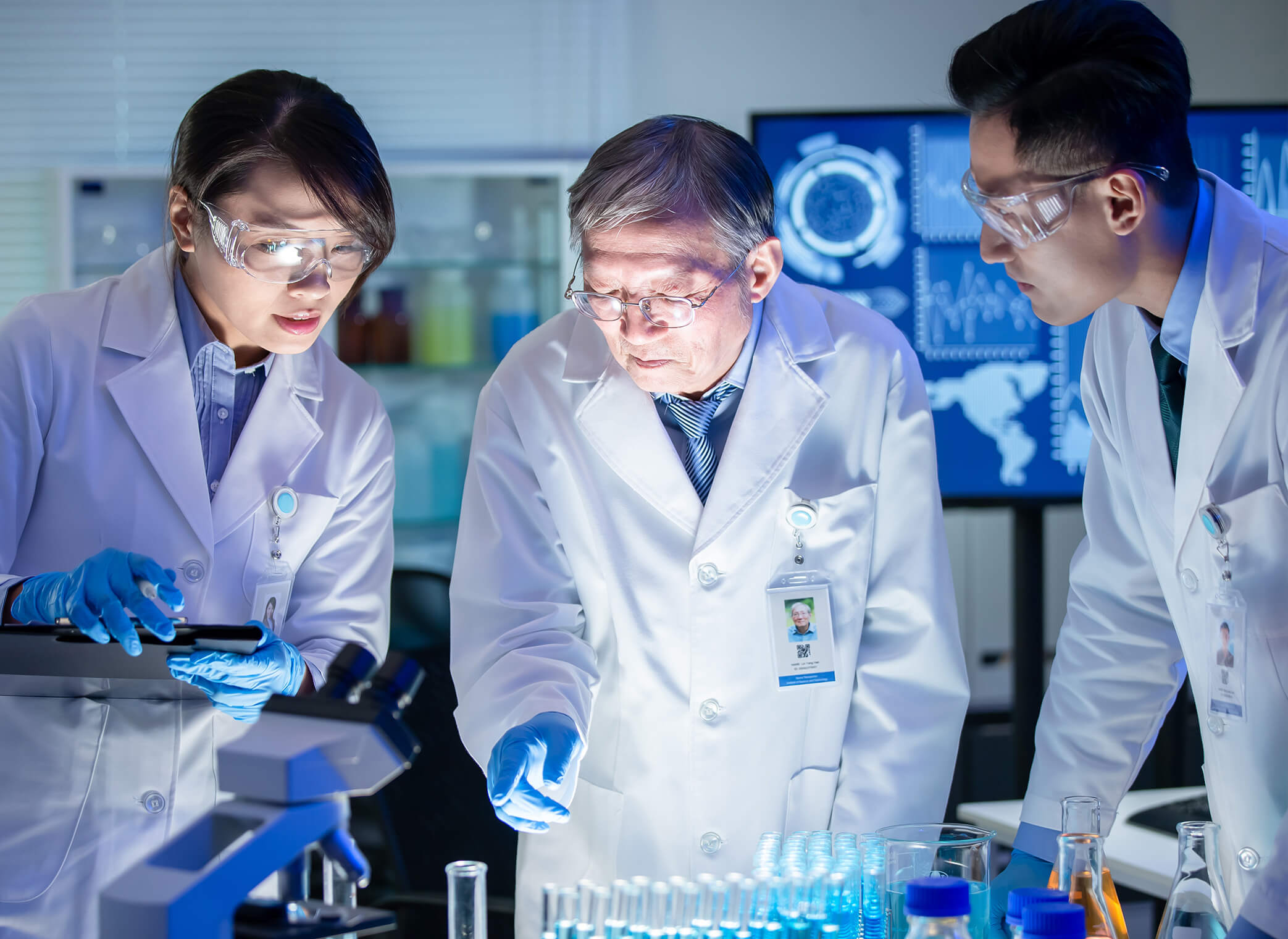 Three scientists discussing in a lab