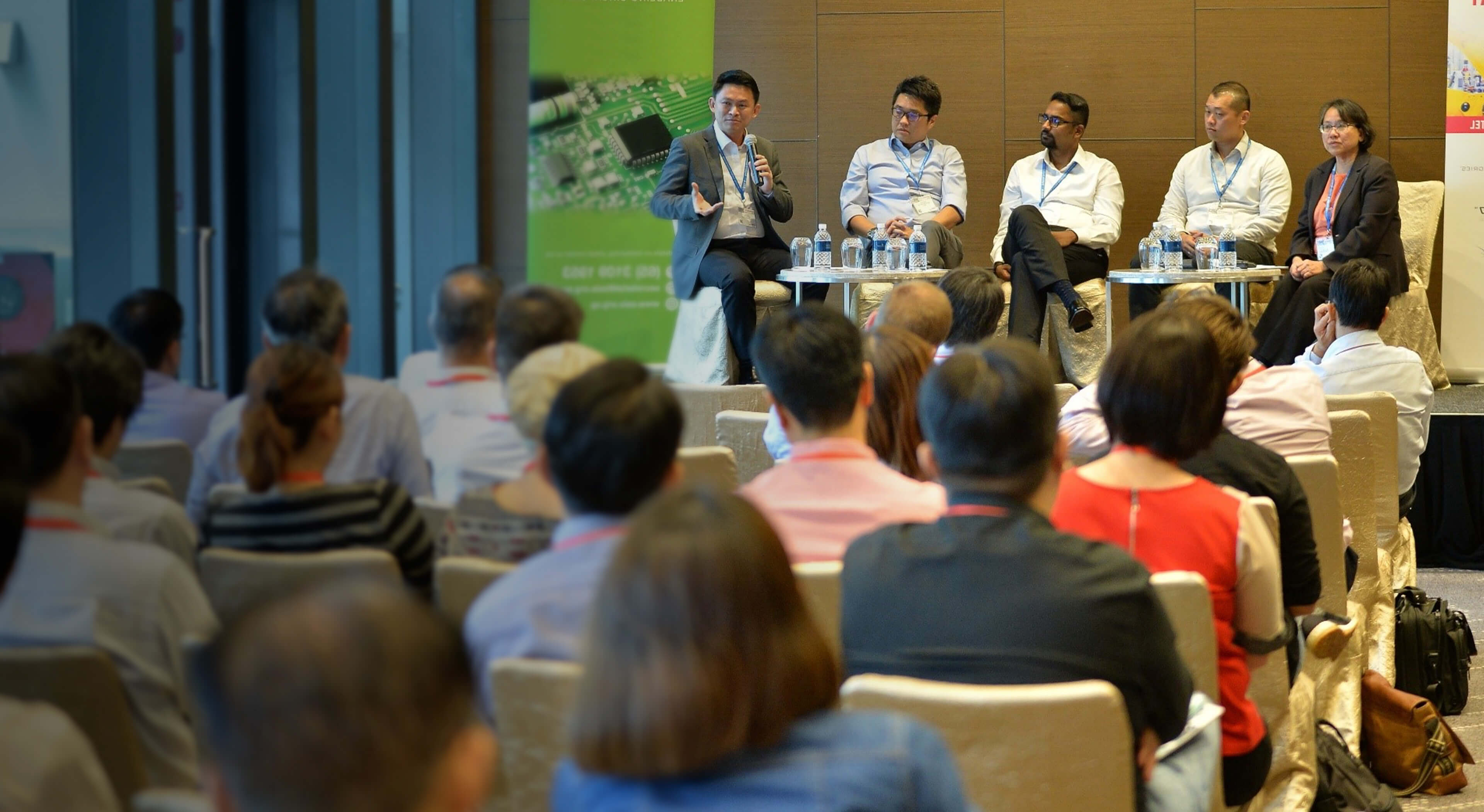 Speakers sharing about semiconductors at a conference