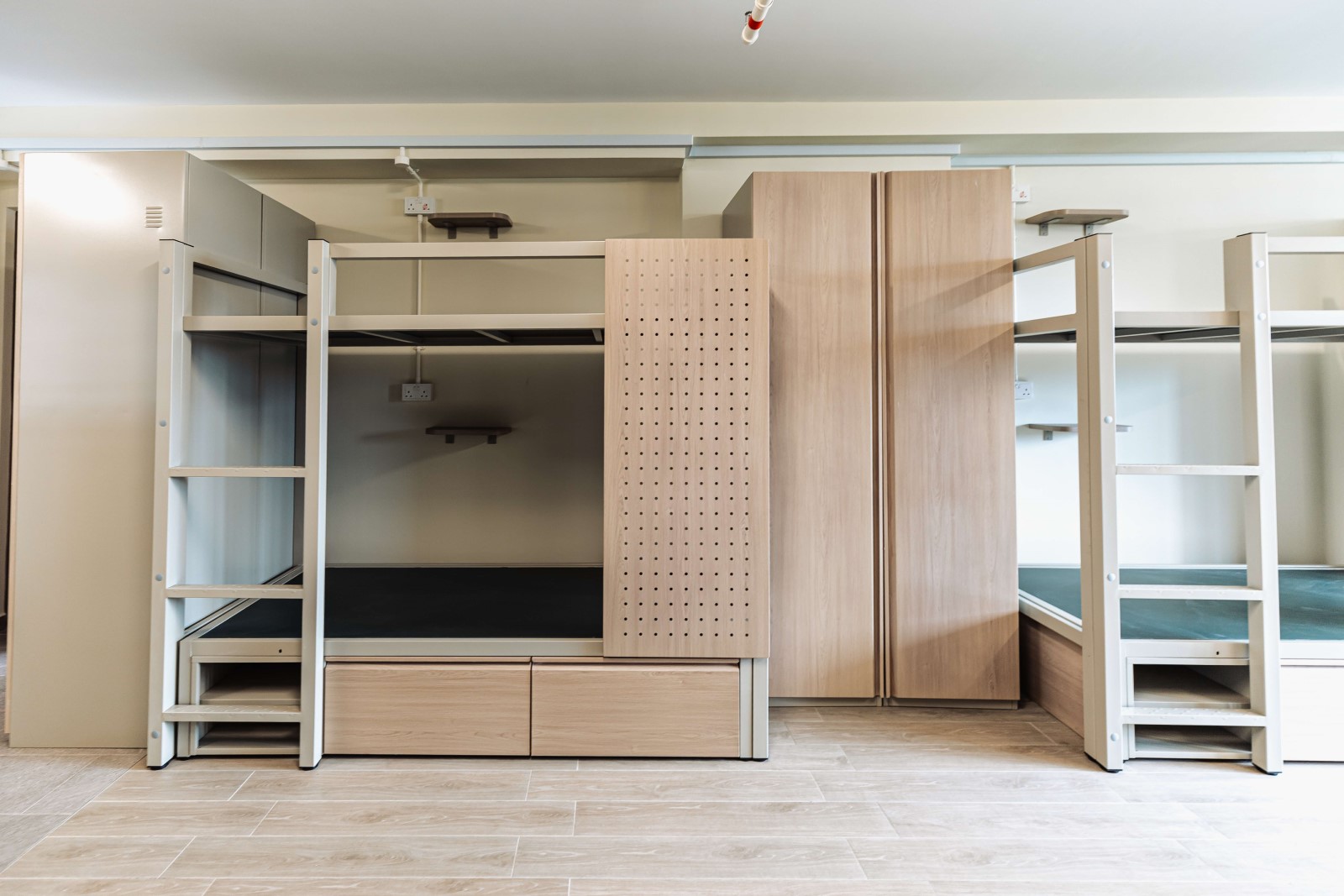 Each bedroom achieves cross-ventilation through windows on opposite ends, improving natural airflow and thermal comfort.