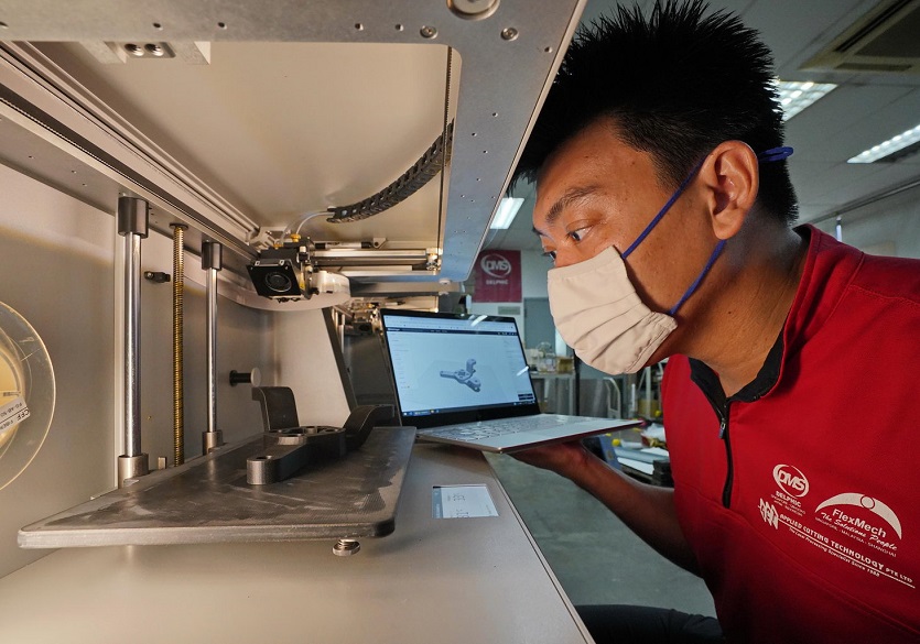 Mr Tan Ru Jin, Managing Director of Flexmech operating the legacy machine installed with sensors that track the machine’s acoustics and vibrations.